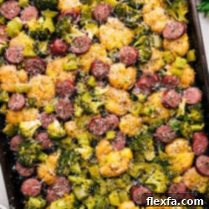 A delicious serving of Sausage Potato Broccoli Sheet Pan with roasted ingredients.