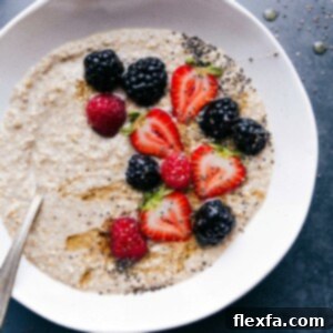 Finished breakfast dish topped with fresh berries, chia seeds, and honey, offering a warm and healthy start to the day.