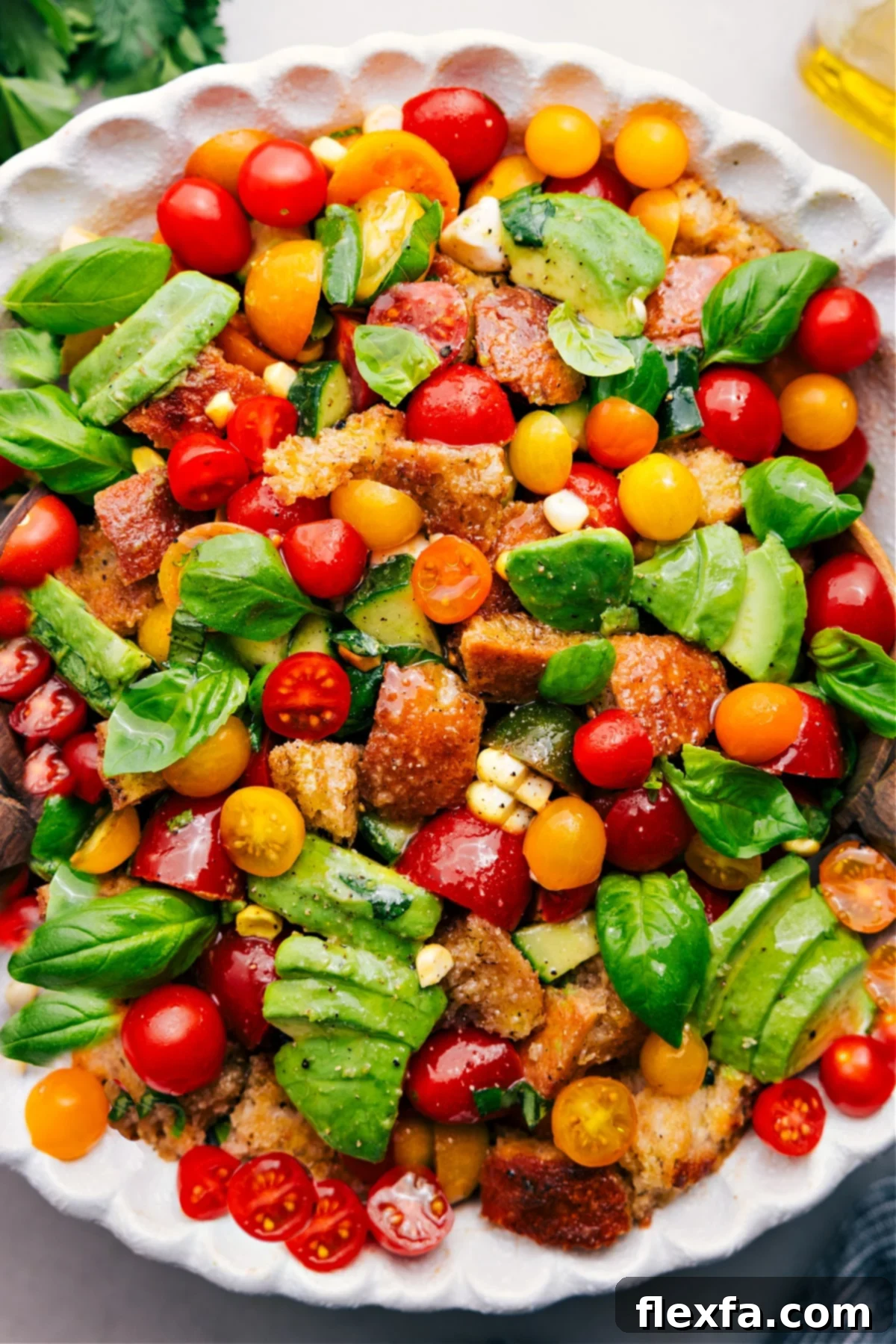 Panzanella salad with fresh tomatoes, avocado, basil, corn, and bread. A perfect summer meal.