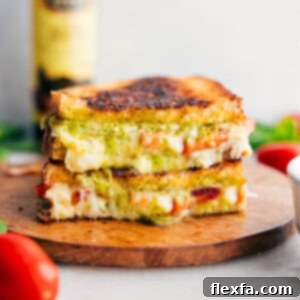 Caprese Grilled Cheese stacked on top of each other showing the cheesy center.
