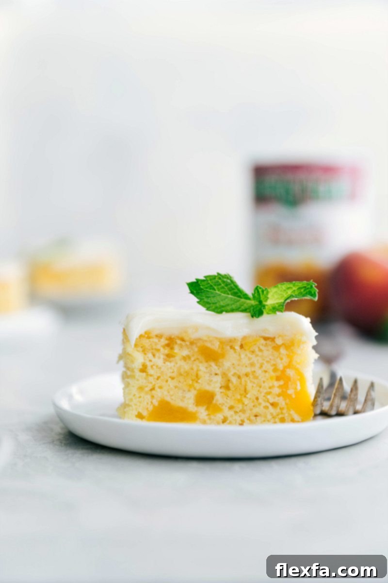 Delicious Peaches and Cream Cake with Cream Cheese Frosting A beautifully frosted Peaches and Cream Cake, adorned with fresh peach slices, ready to be served.