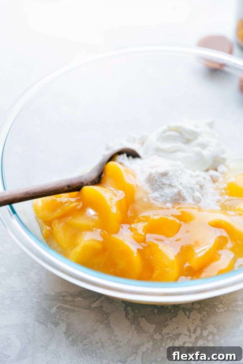Mixing Cake Ingredients with Peach Filling A close-up shot of yellow cake mix and sweet peach pie filling being gently mixed together in a large bowl, preparing for a delicious peaches and cream cake.