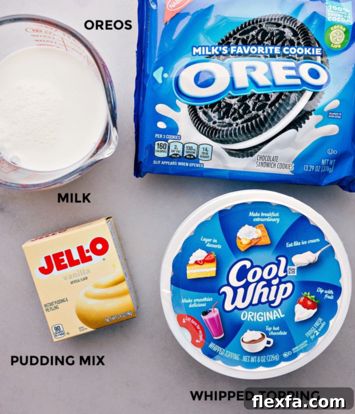 Our Favorite Oreo Fluff Ingredients All the ingredients used in this recipe prepped out for easy assembly, including milk, pudding mix, whipped topping, Oreos, and marshmallows.