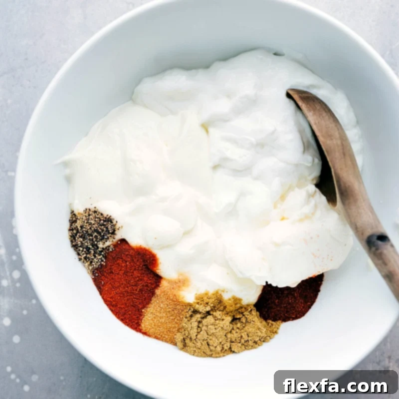 Mixing Seasonings and Sour Cream for Creamy Corn Salad Dressing Various seasonings and smooth sour cream are combined in a mixing bowl, ready to be whisked into a rich dressing for the creamy corn salad.