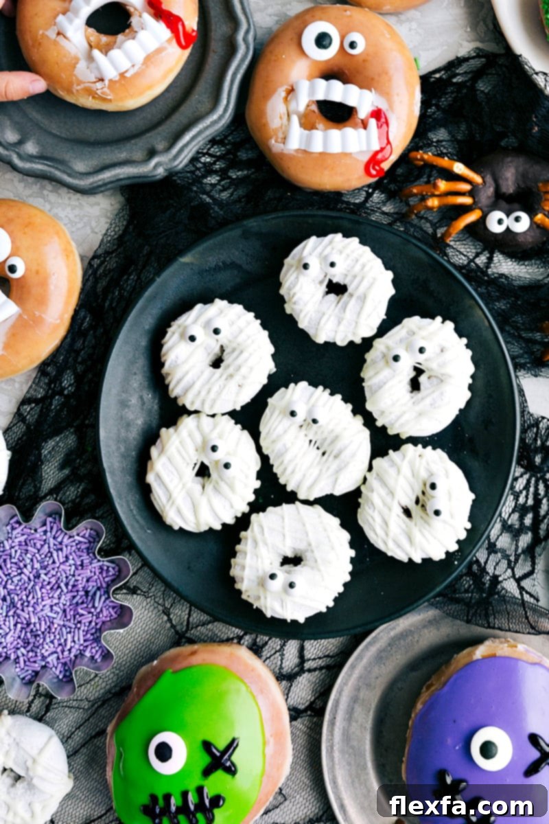 Eerie Mummy Donuts adorned with white chocolate drizzles to create bandages and topped with small candy eyes.