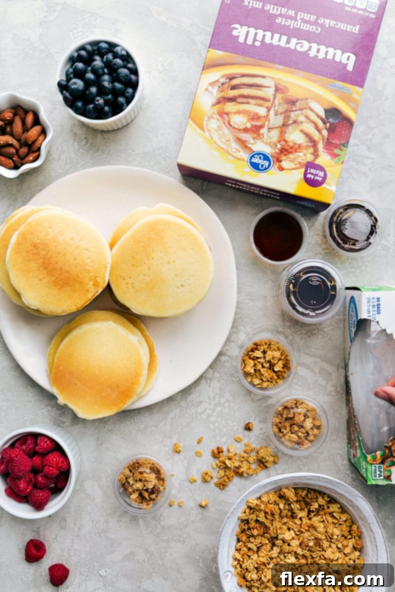Pancakes with toppings such as granola, fruit, and nuts, with syrup in containers, ready to make a perfect lunch as part of kids school lunch ideas.