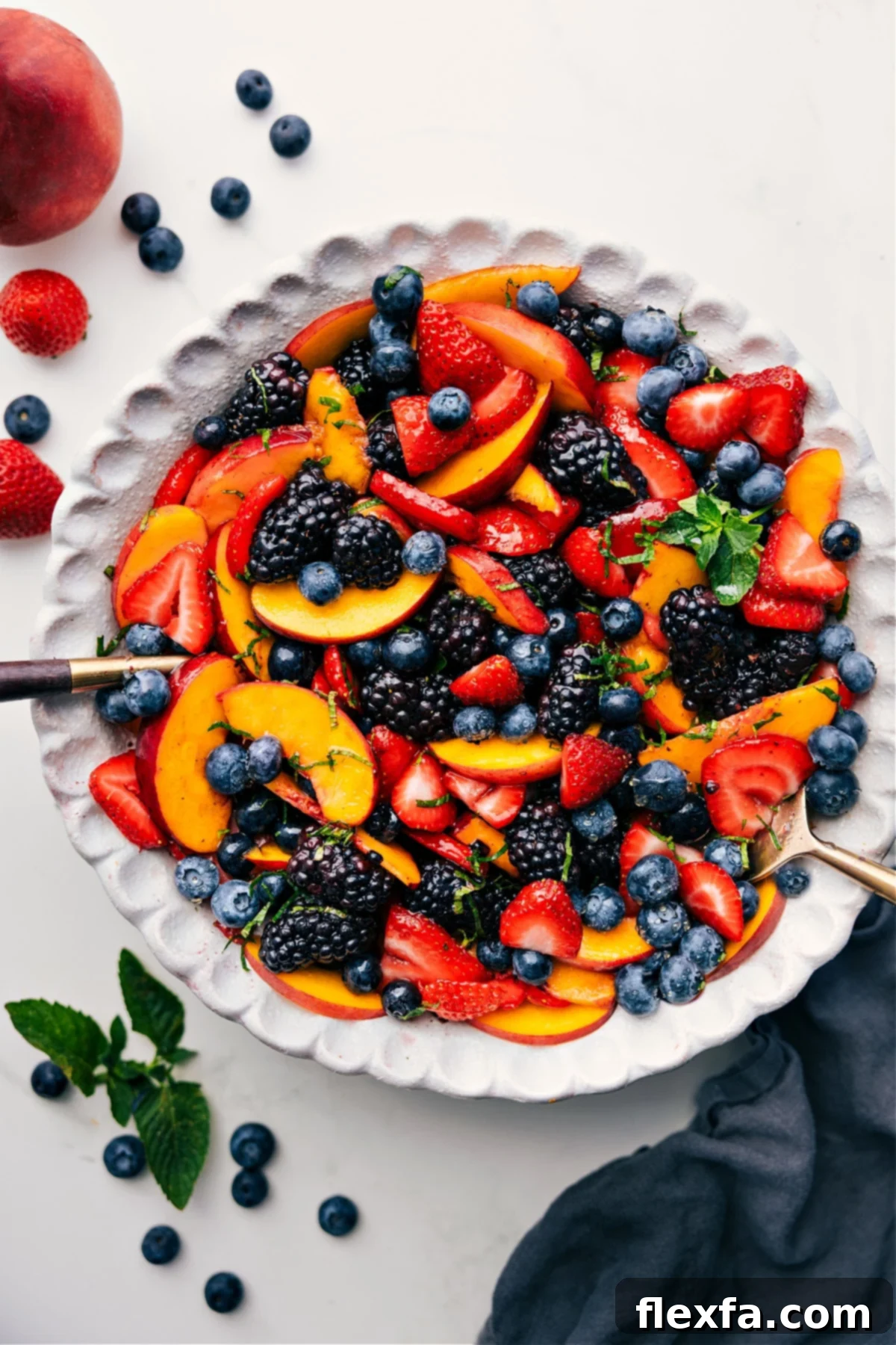 Vibrant Peach Fruit Salad tossed with fresh berries and a zesty citrus dressing, ready to be served.