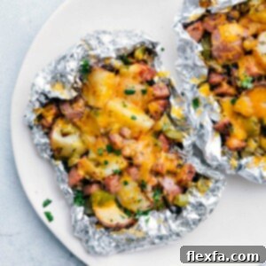 Cheesy Sausage & Potato Foil Pack with melted cheese and fresh cilantro