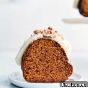 A beautifully decorated pumpkin cake, topped with a smooth cream cheese frosting, ready for serving.