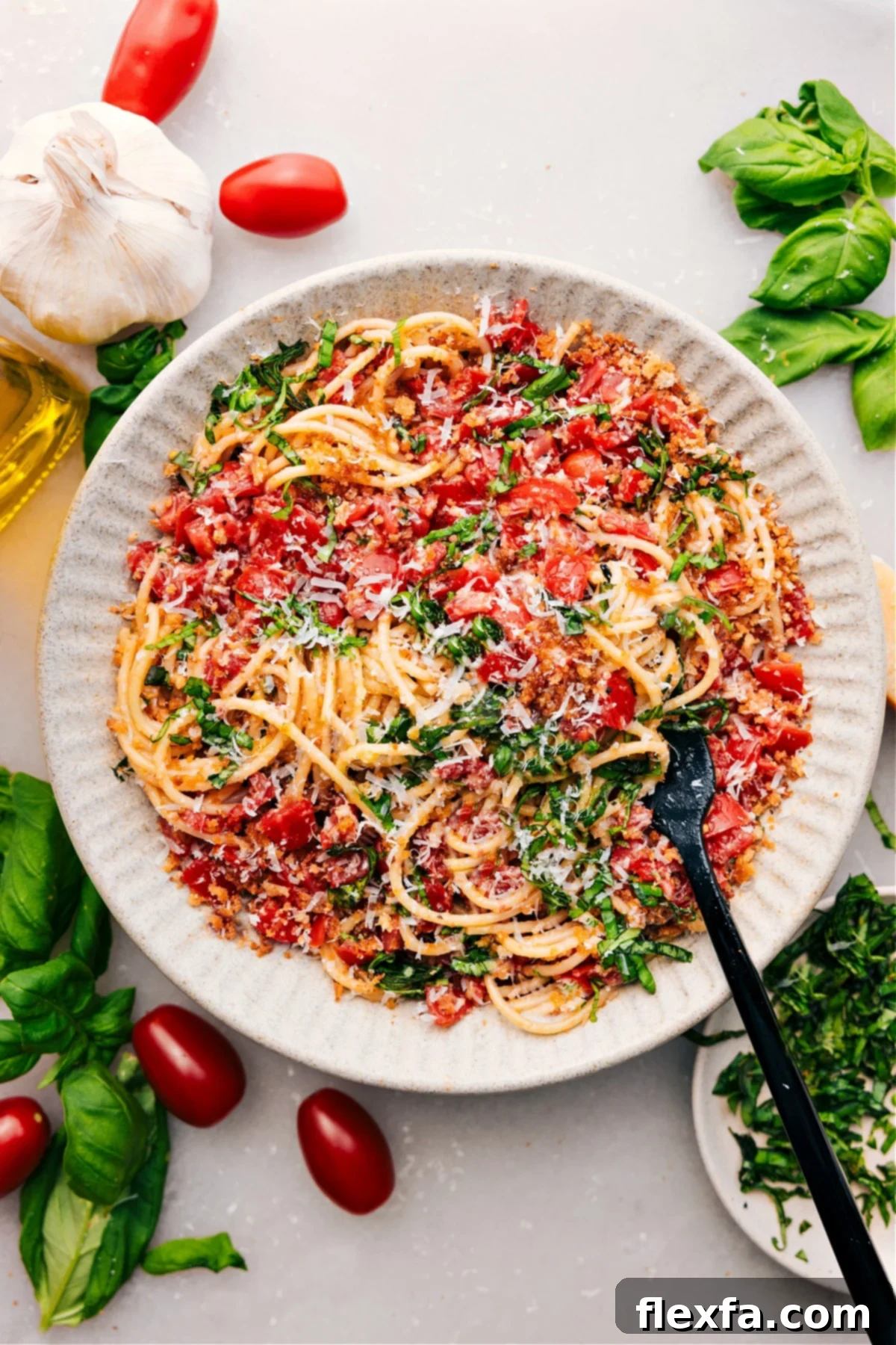 Garden Fresh Bruschetta Pasta 2 A vibrant bowl of freshly made bruschetta pasta, garnished with fresh basil and Parmesan cheese.