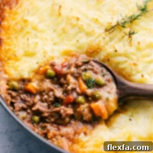 A finished skillet of golden-brown Shepherd's Pie, ready to be served.