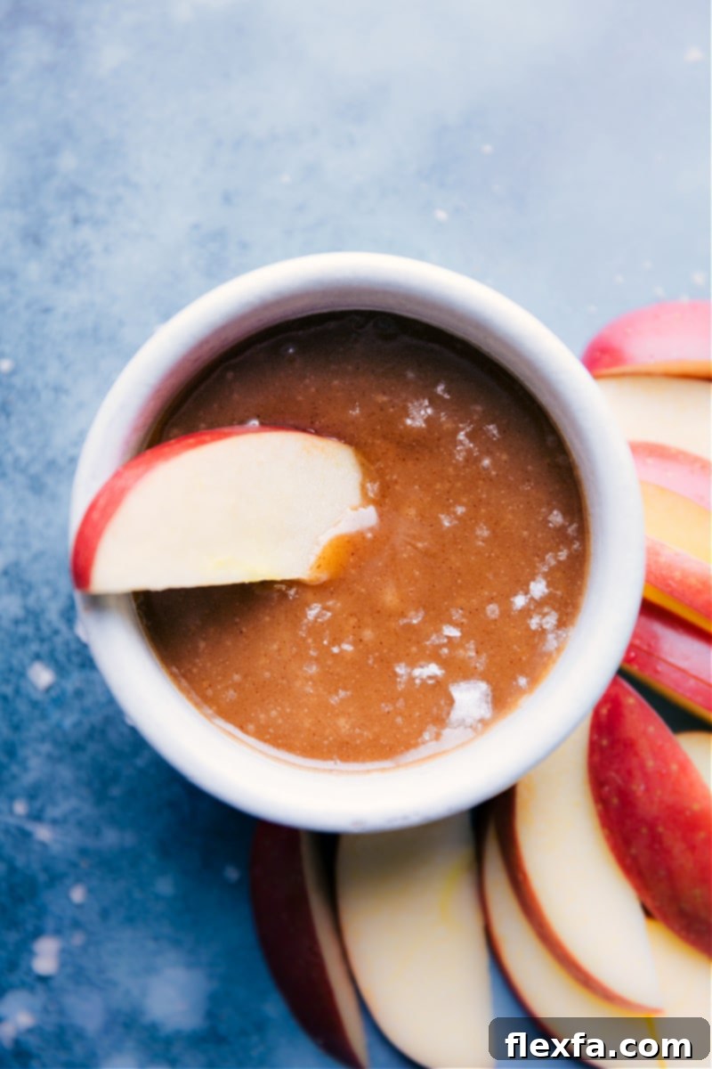 Crisp apple slice dipped in homemade Healthy Caramel Sauce