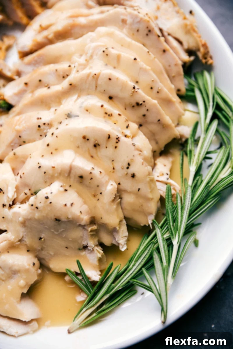 Succulent slices of roasted turkey lavishly drizzled with rich, homemade gravy, beautifully presented on a serving platter.