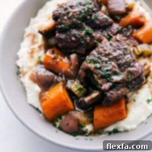The finished Short Ribs Recipe, served with vegetables and gravy.