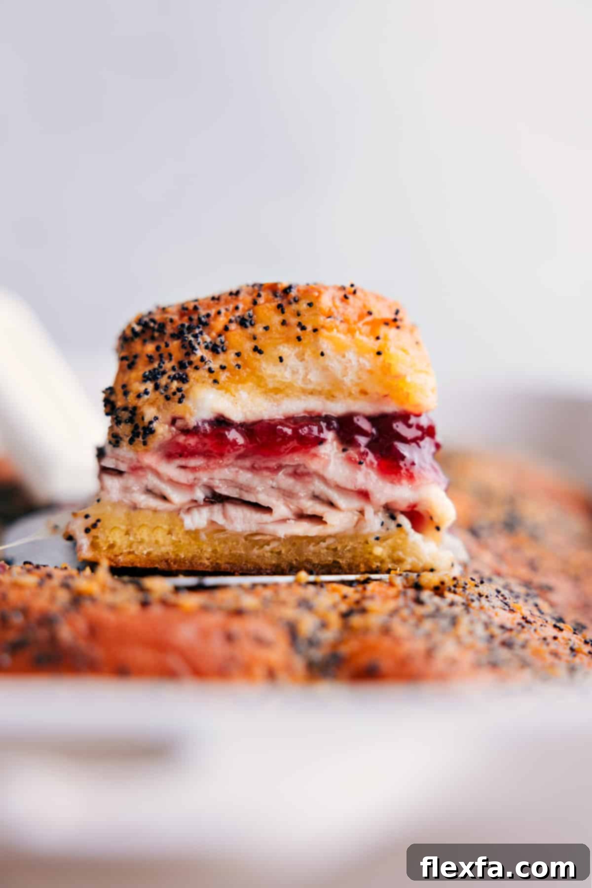 Stacked Turkey Cranberry Sliders, golden brown and ready to be enjoyed, showcasing the melted cheese and juicy filling.