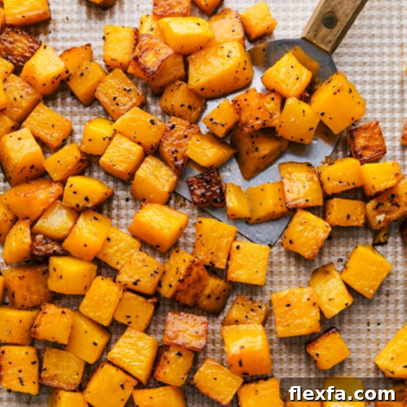 Roasted butternut squash cubes, golden brown and fresh out of the oven, ready for the salad.