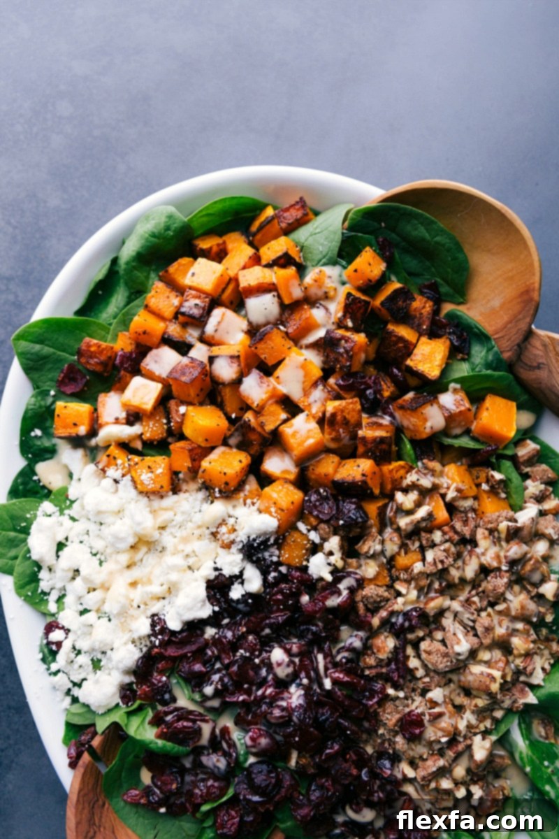 Butternut Squash Salad dressed with vinaigrette and garnished, ready to be eaten.