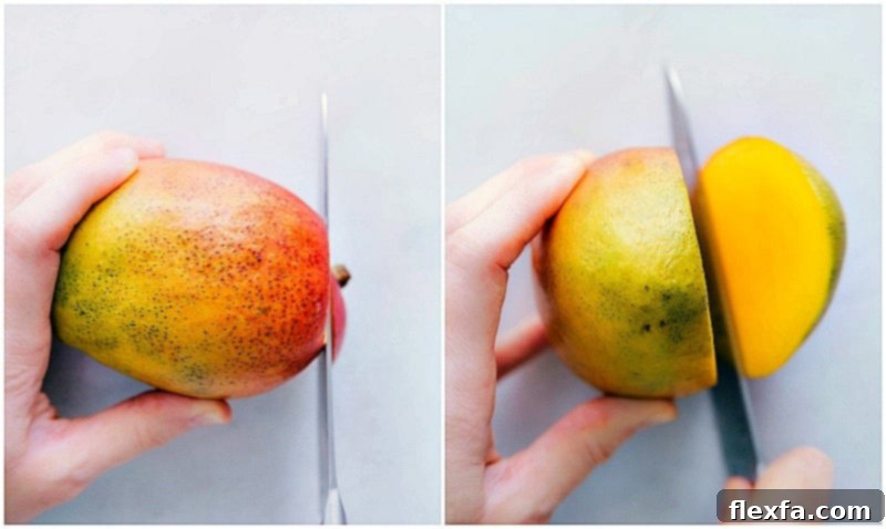 A mango being prepared for cutting, with the stem end being sliced off to create a stable base on a cutting board.