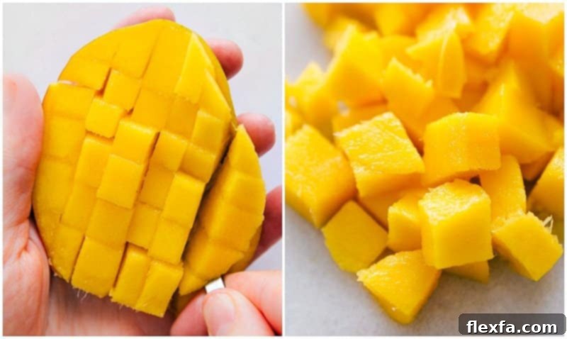 A mango cheek with vertical cuts is now being scored horizontally, creating a grid pattern for easy cubing without removing the skin.