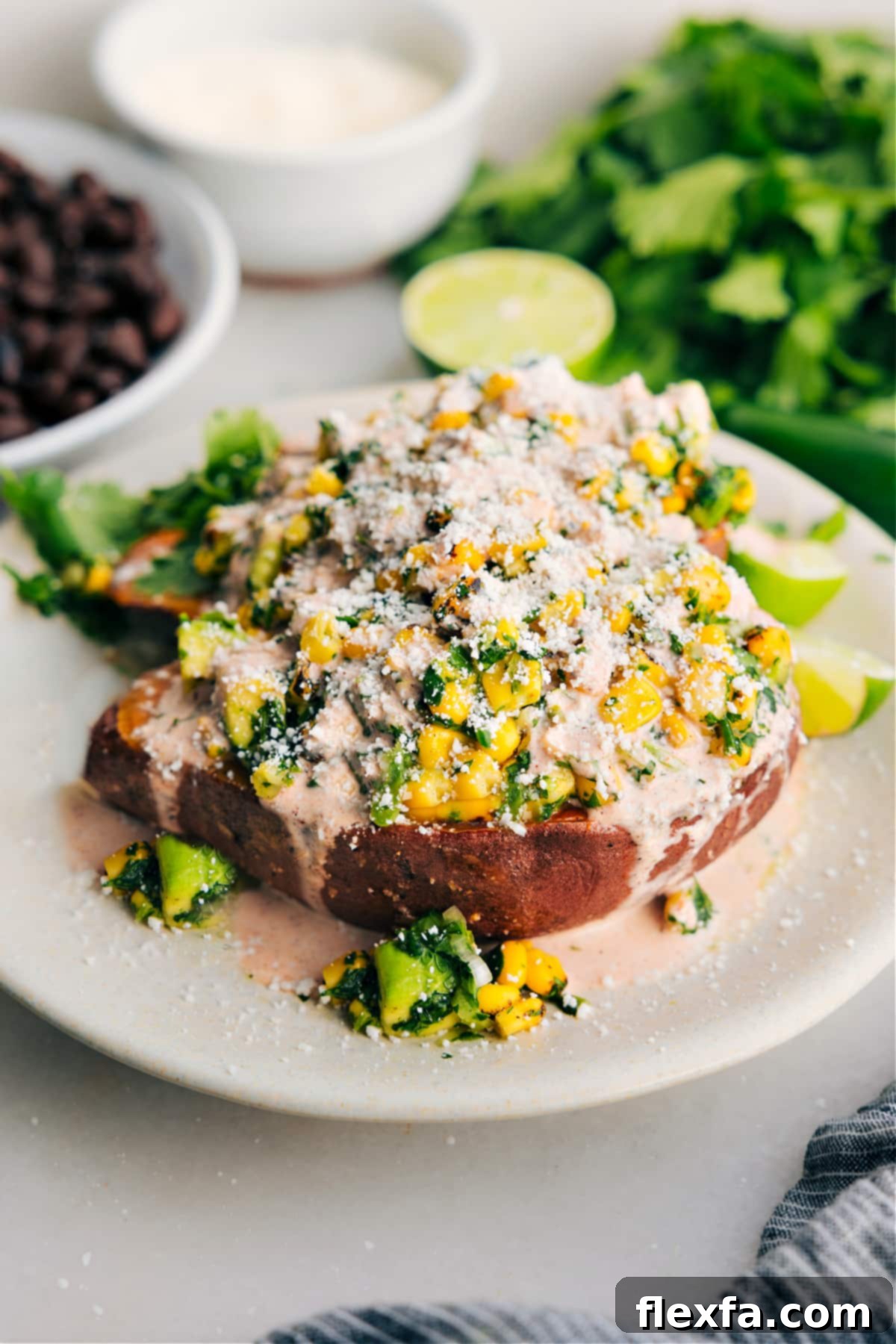 Delicious Mexican street corn loaded sweet potatoes topped with a creamy sauce, fresh cilantro, and cotija cheese.