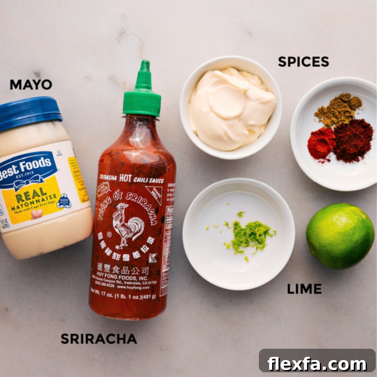 All the ingredients for the creamy Sriracha-lime sauce are prepped and ready: mayonnaise, lime, chili powder, paprika, ground cumin, and Sriracha.