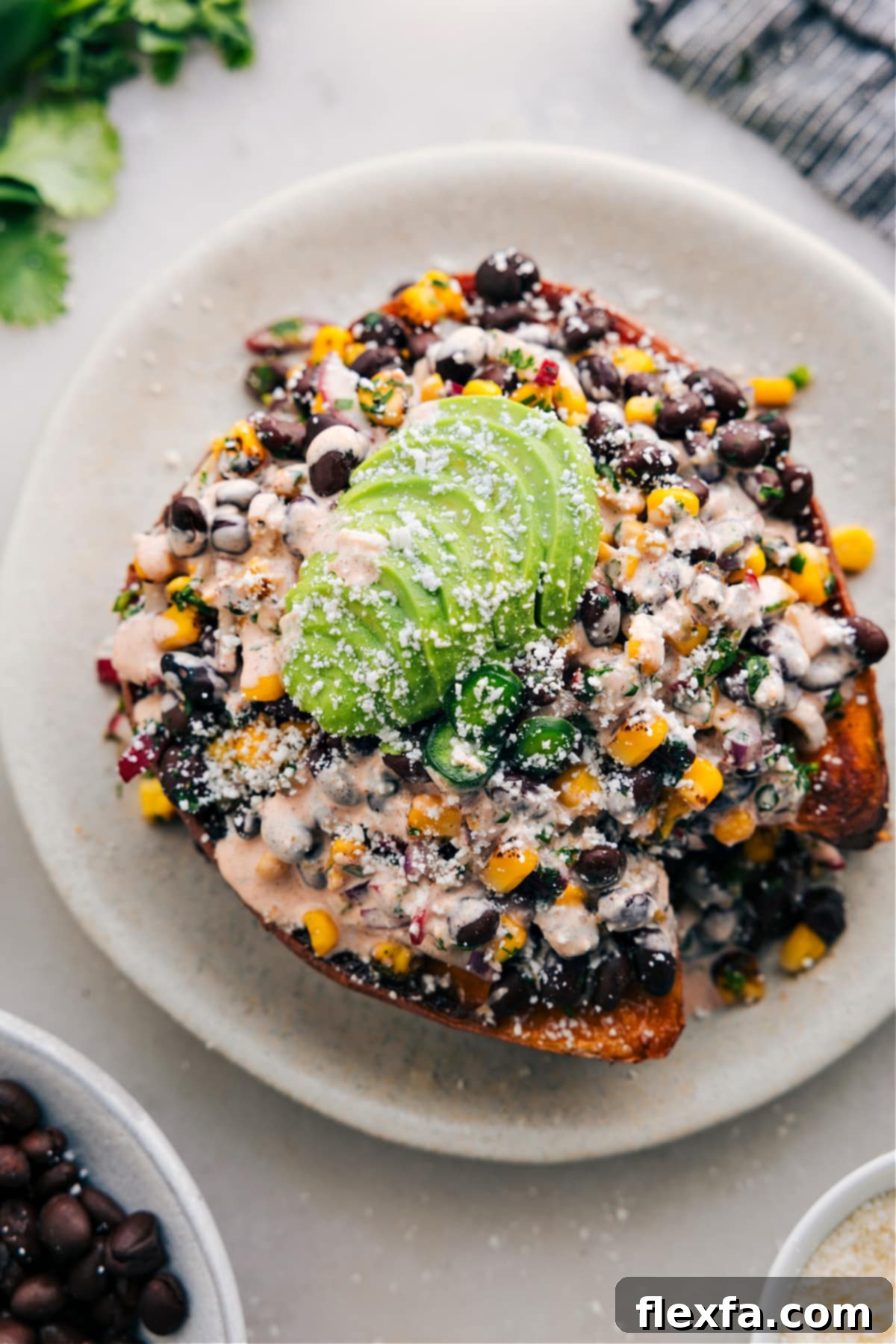 Southwestern Stuffed Sweet Potatoes, garnished with fresh cilantro and a creamy drizzle.