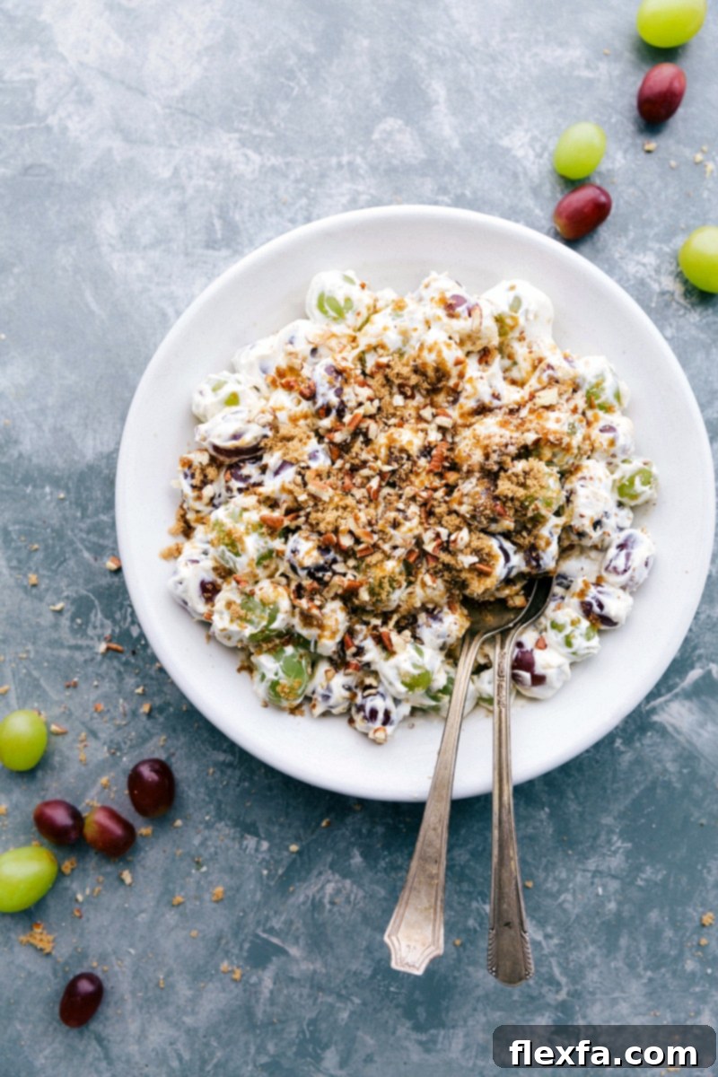 Classic Creamy Grape Salad Recipe A beautifully presented Grape Salad, generously topped with glistening brown sugar and toasted pecans, ready to be served.