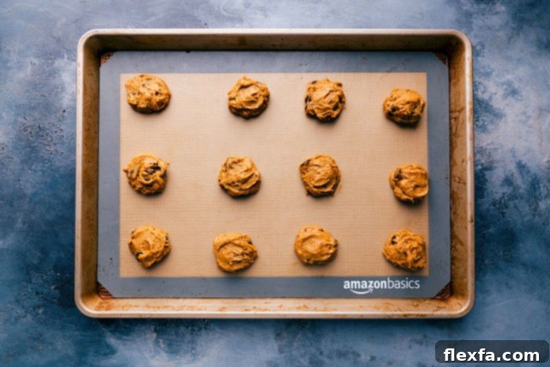 Pumpkin Cookie Dough Ready for Baking Portioned scoops of pumpkin cookies with cake mix dough arranged on a sheet pan, ready for baking.