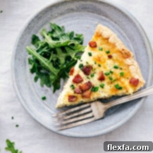 Finished and ready to eat Quiche Lorraine, sliced and serving.