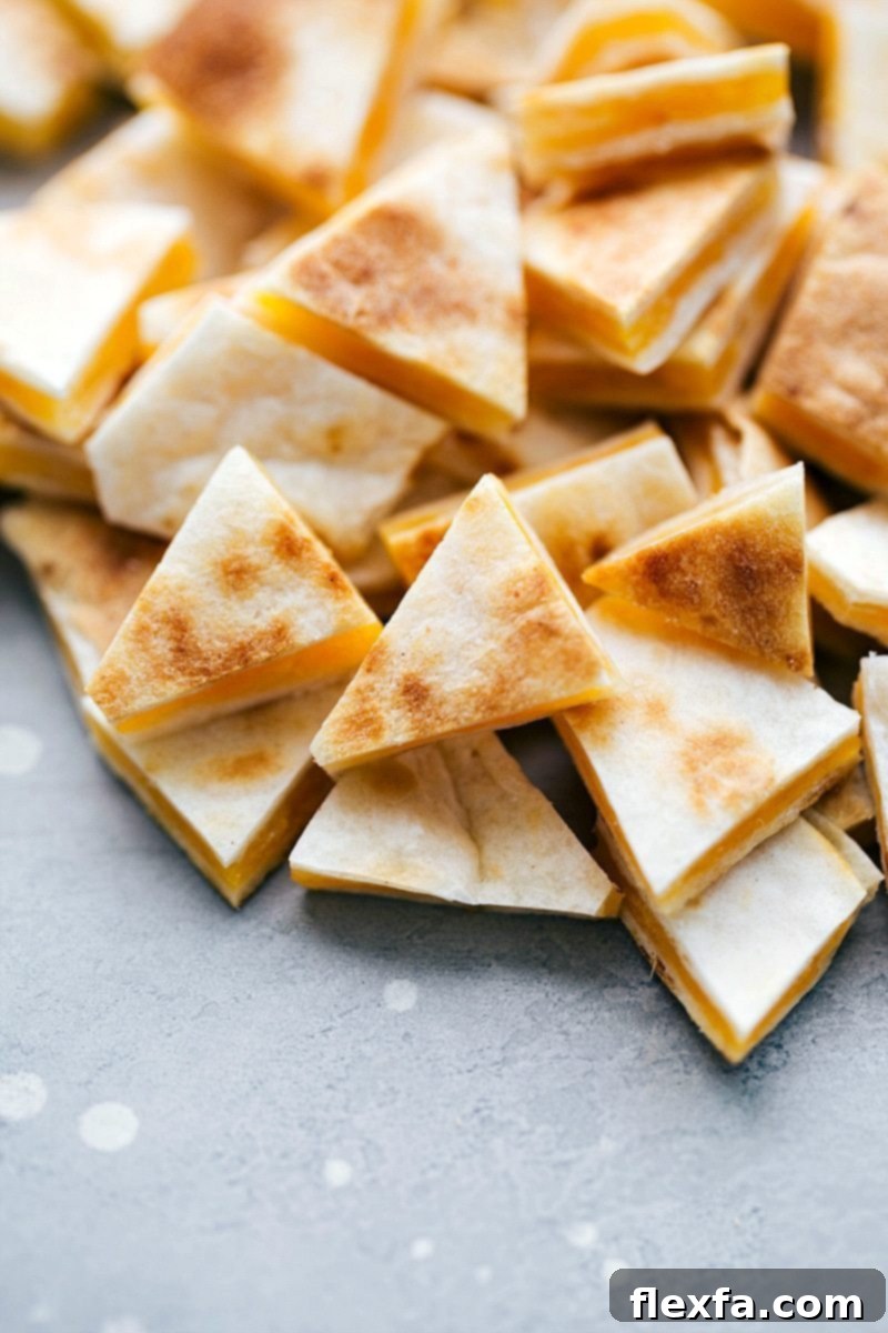 The BEST EVER Crockpot Chicken Quesadilla Soup! Dump it and forget about it and then serve with 2-ingredient quesadilla croutons! It tastes just like the Campbell's chicken quesadilla soup! recipe from chelseasmessyapron.com #chicken #soup #quesadilla #crockpot #slowcooker Image of the mini cut quesadilla pieces that goes into this knock off campbell's chicken quesadilla soup