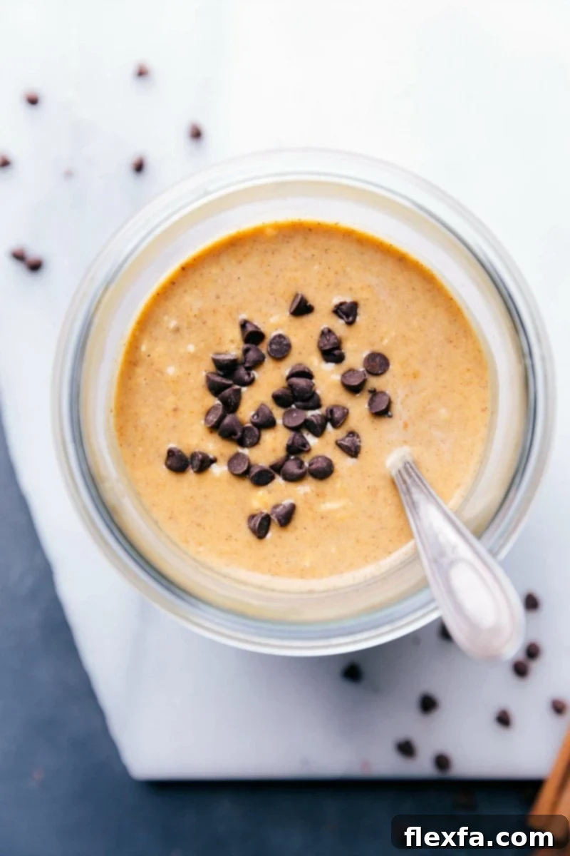 Ready-to-Enjoy Pumpkin Chocolate Chip Overnight Oats for On-The-Go A jar of pumpkin overnight oats generously topped with chocolate chips, ready for a quick and satisfying on-the-go breakfast.