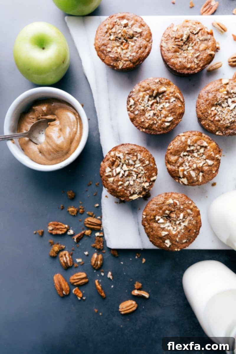 Freshly baked gluten-free apple muffins ready to be enjoyed, showcasing their golden-brown tops and apple chunks.