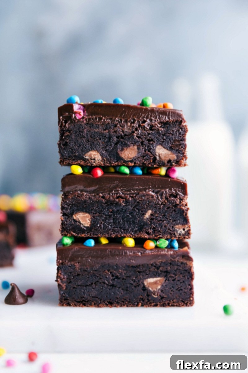 Nostalgic Cosmic Brownies - Stacked and Topped with Colorful Candies Homemade cosmic brownies stacked, showcasing its delicious layers, and topped with colorful candies - a nostalgic and delicious treat.