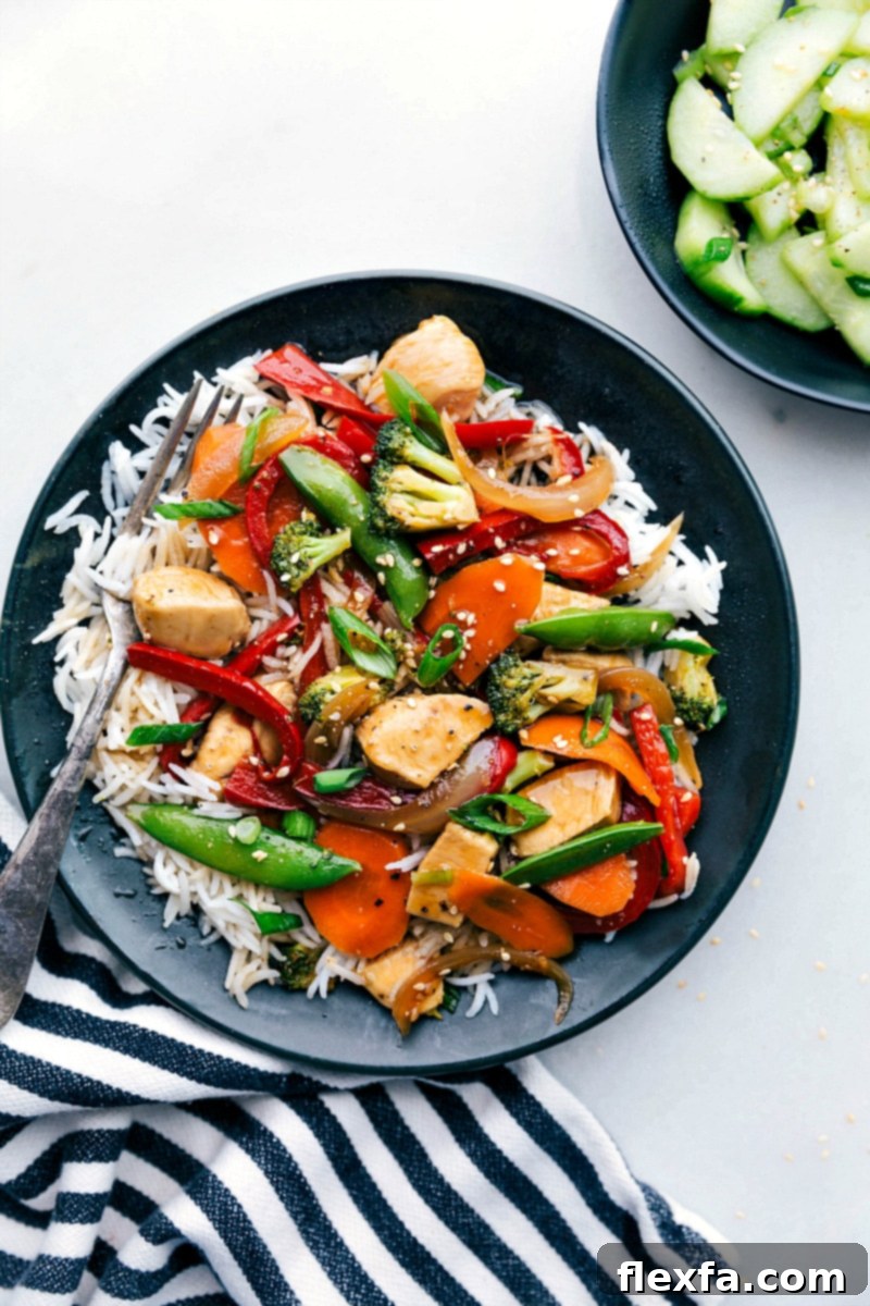 Flavor-packed stir fry chicken served in a bowl over a bed of rice, ready to be enjoyed.