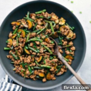 Pork stir fry sizzling in a skillet, seasoned to perfection and ready for a delightful meal.