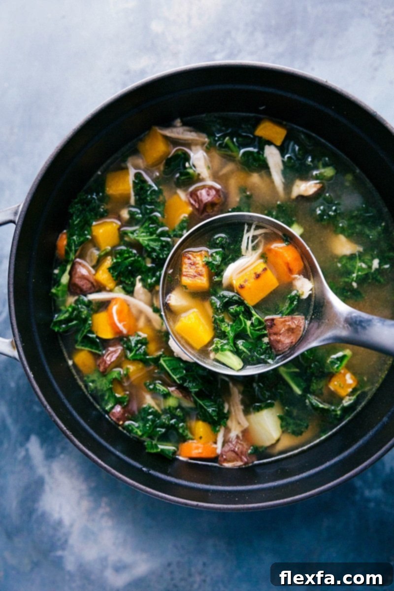 Steaming chicken vegetable soup in a rustic pot, with a ladle ready to serve a delicious portion.
