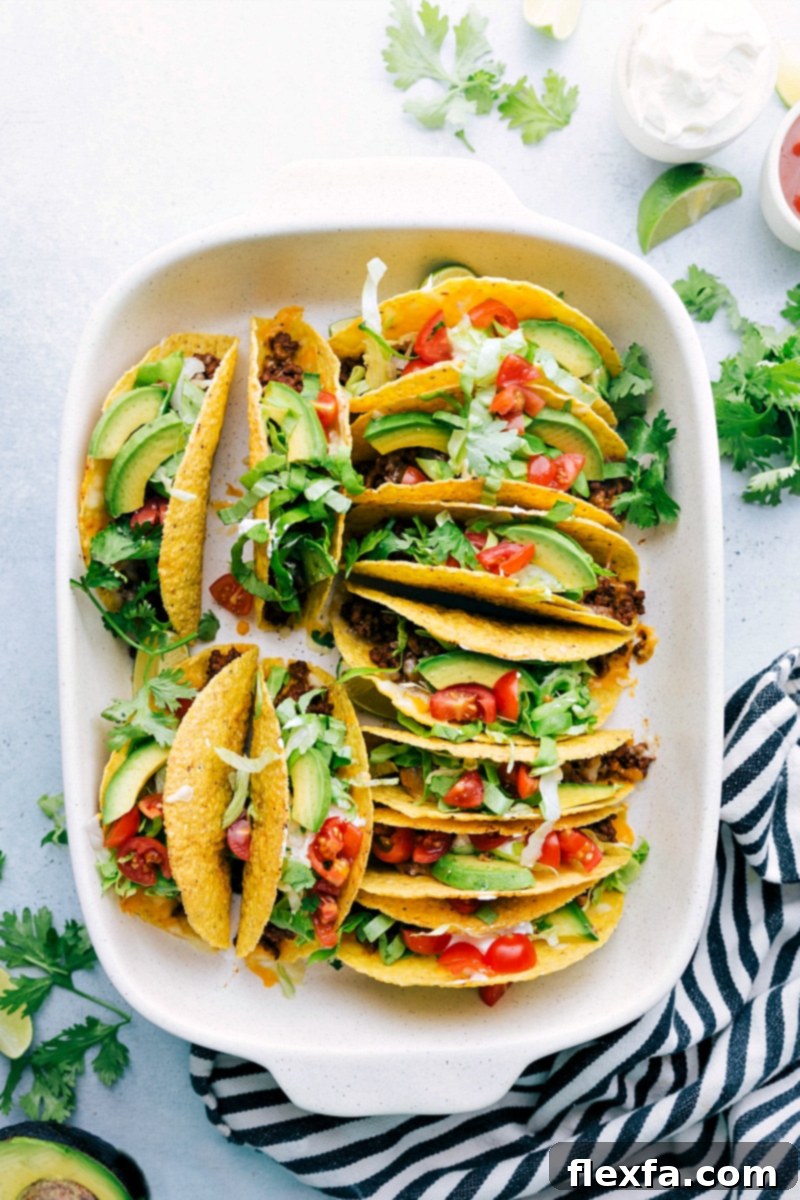 A stunning final presentation of fresh-from-the-oven beef tacos, generously adorned with a colorful assortment of toppings, creating a perfect and enticing meal.