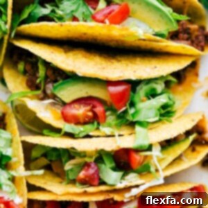 Delicious savory beef tacos in a casserole dish, fully assembled with all the toppings.