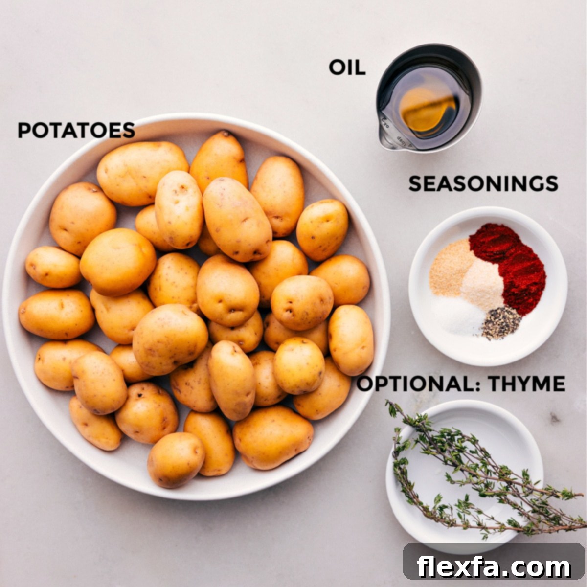All the ingredients for crispy roasted potatoes prepped on a wooden board.