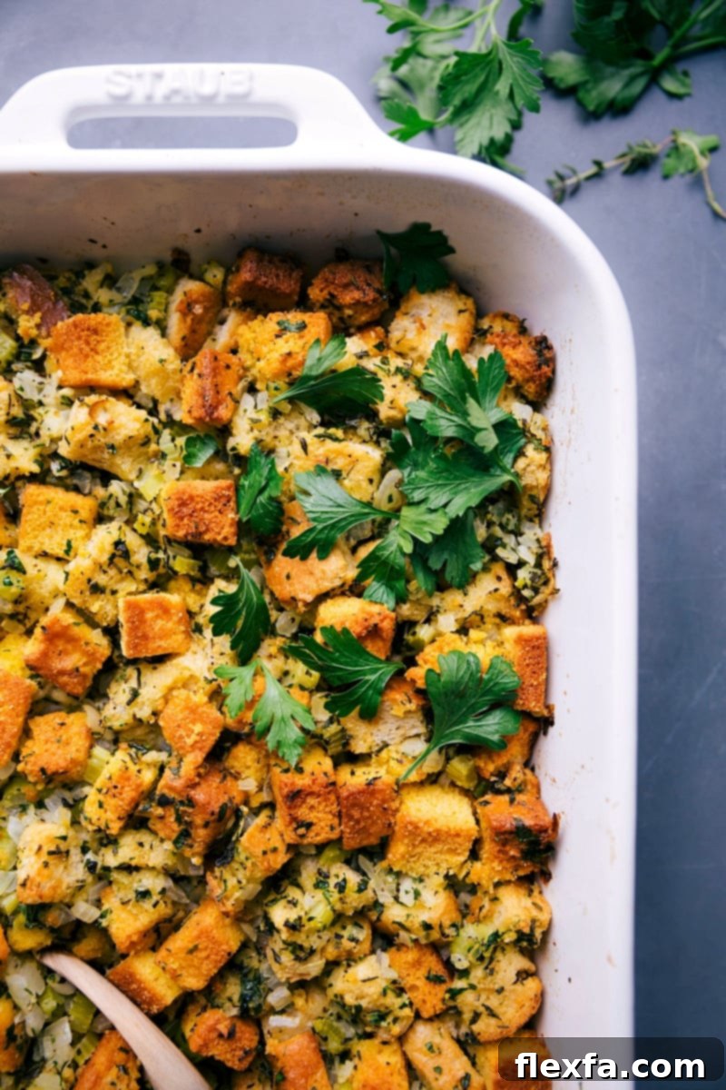 A freshly baked, golden-brown cornbread dressing, hearty and inviting, placed on a table, ready to be enjoyed as a comforting meal.