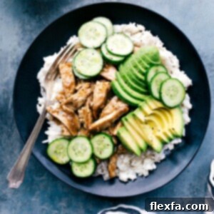 Apricot chicken in a bowl with rice, avocado, and cucumbers, a delicious and balanced meal, showcasing the completed dish.