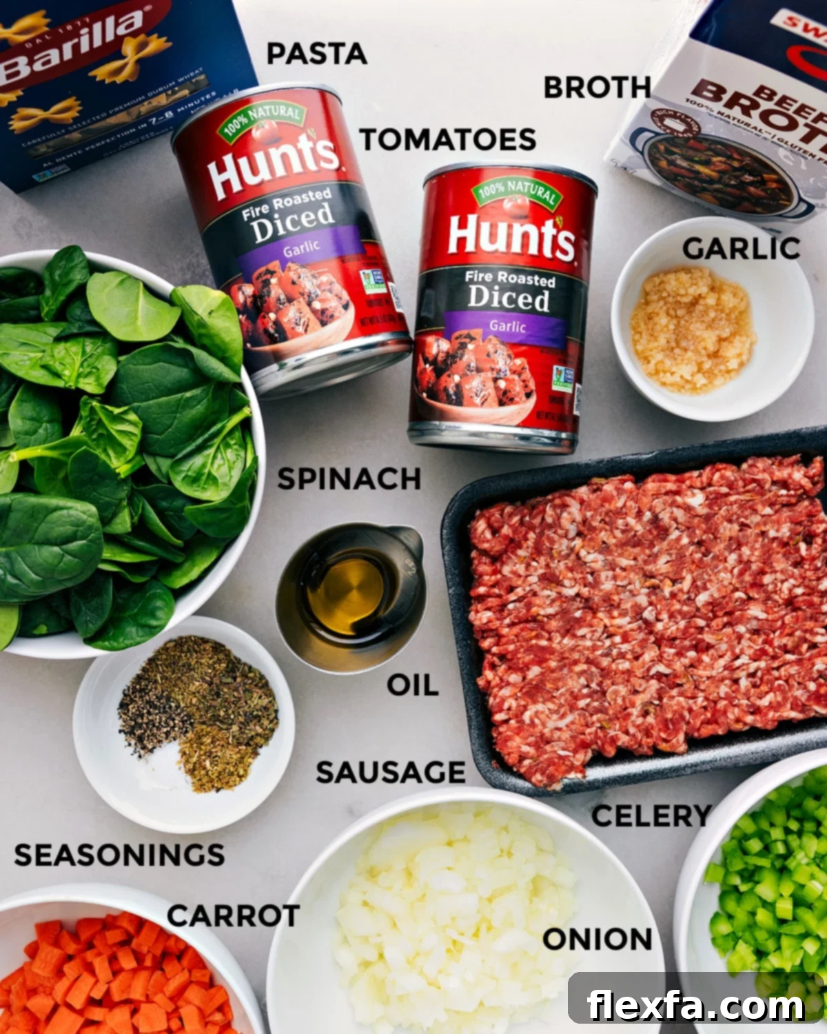 All essential ingredients for Pasta Soup — including beef broth, fresh garlic, diced tomatoes, pasta, Italian sausage, spinach, olive oil, and various seasonings — are neatly prepped and laid out for cooking.