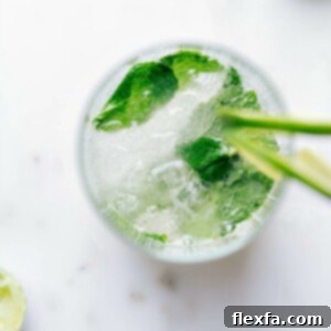 A refreshing virgin mojito topped with fresh mint leaves, served in a tall glass.