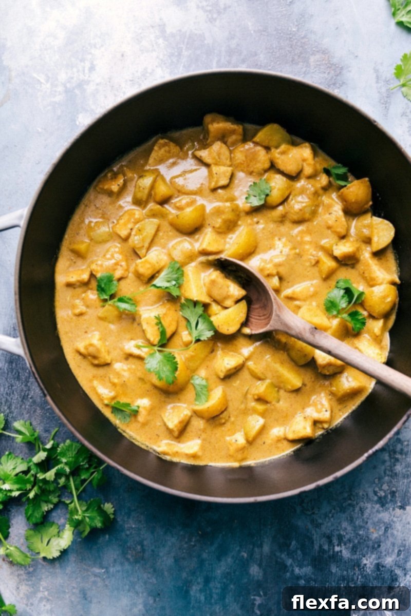 A beautifully prepared dish of Thai Yellow Chicken Curry, rich and creamy with tender chicken and vegetables, garnished with fresh herbs, ready for serving.