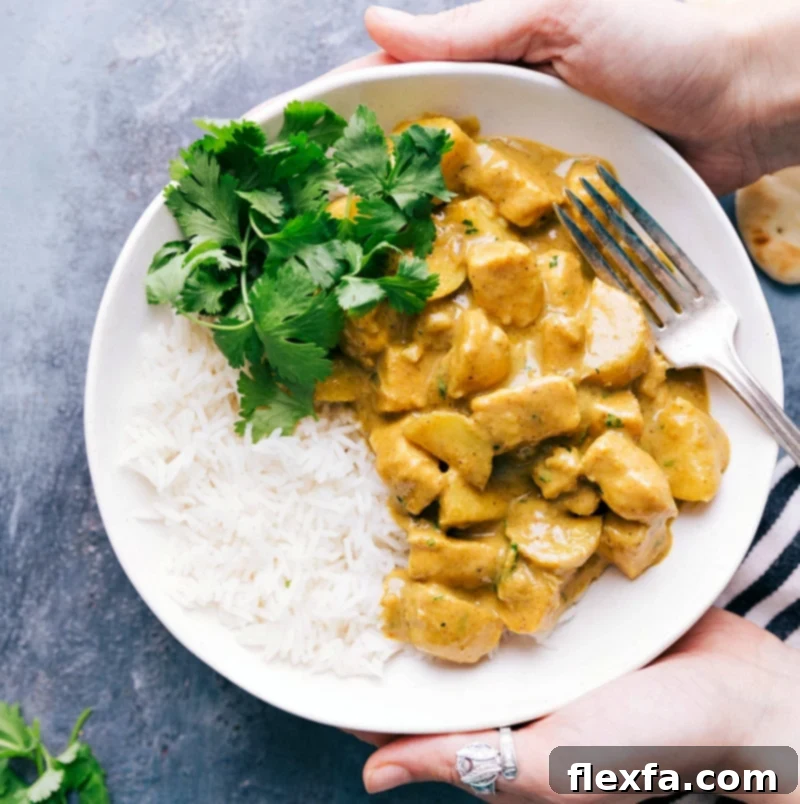 A vibrant and hearty meal of Thai Yellow Chicken Curry, served perfectly on a bed of fluffy rice and garnished with fresh herbs, showcasing a delicious and comforting dish.