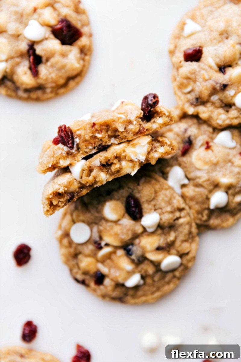 Warm, freshly baked dessert split open, revealing a gooey interior with melted white chocolate chips.
