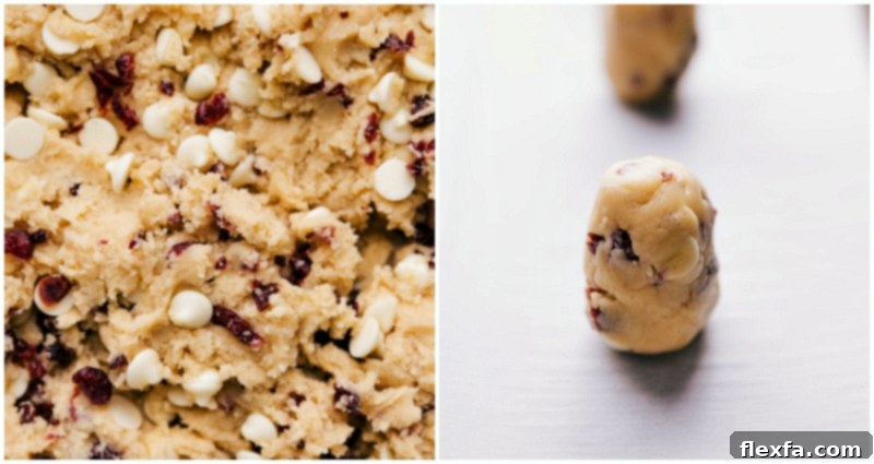 Cookie Preparation: Dough Rolled and Set on Sheet Pan for Baking Neatly arranged cylindrical cookie dough balls are precisely spaced on a baking sheet lined with parchment paper, showcasing perfect preparation and readiness for baking.