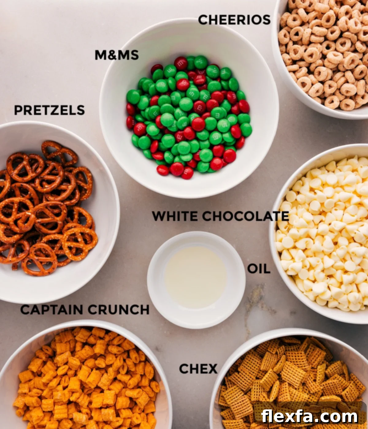 All the ingredients for the Christmas Snack Mix laid out: M&Ms, white chocolate chips, vegetable oil, Chex cereal, Captain Crunch cereal, and pretzels.