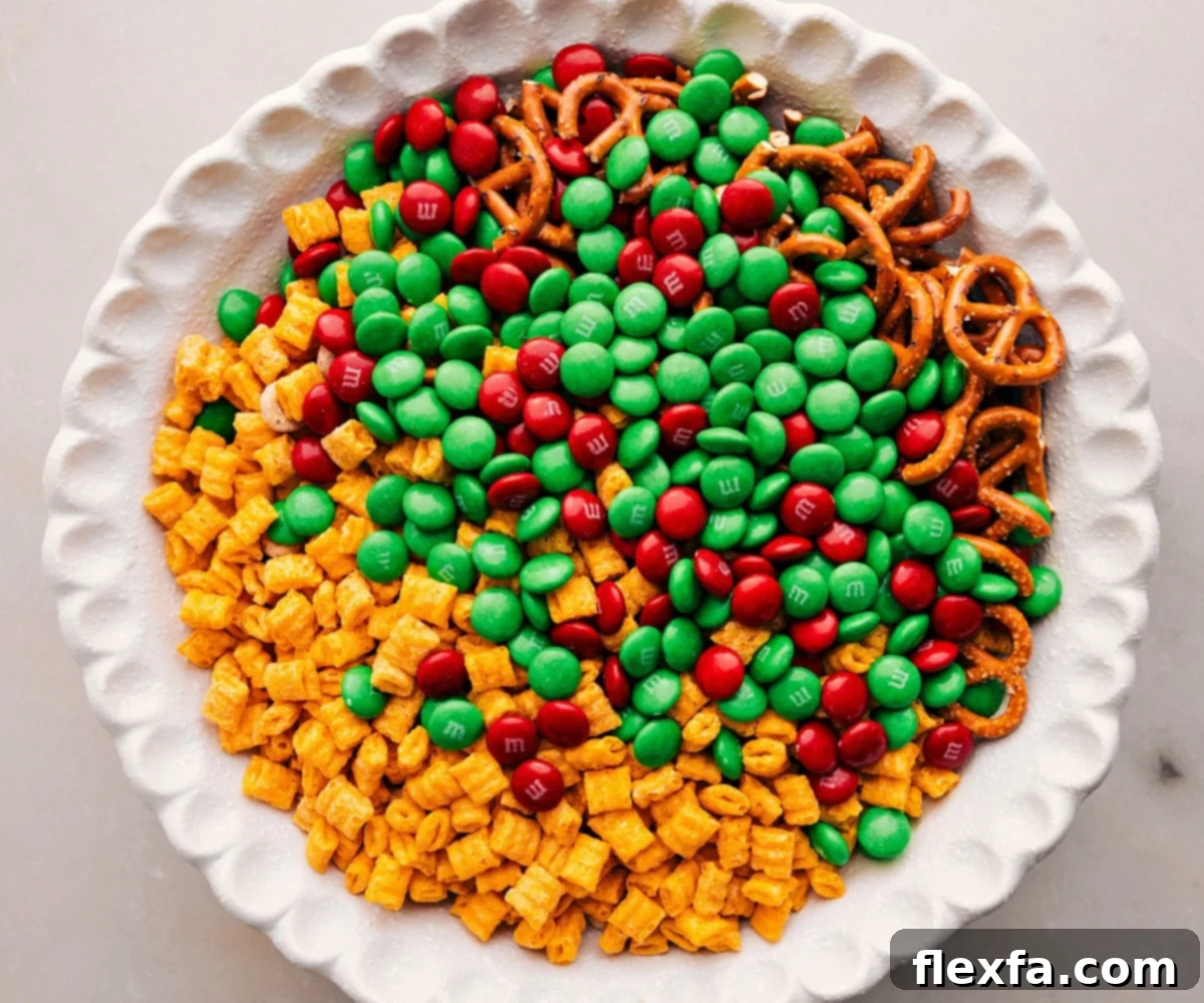 Add all the ingredients except the white chocolate to a large bowl for the Christmas Snack Mix, ready for coating.