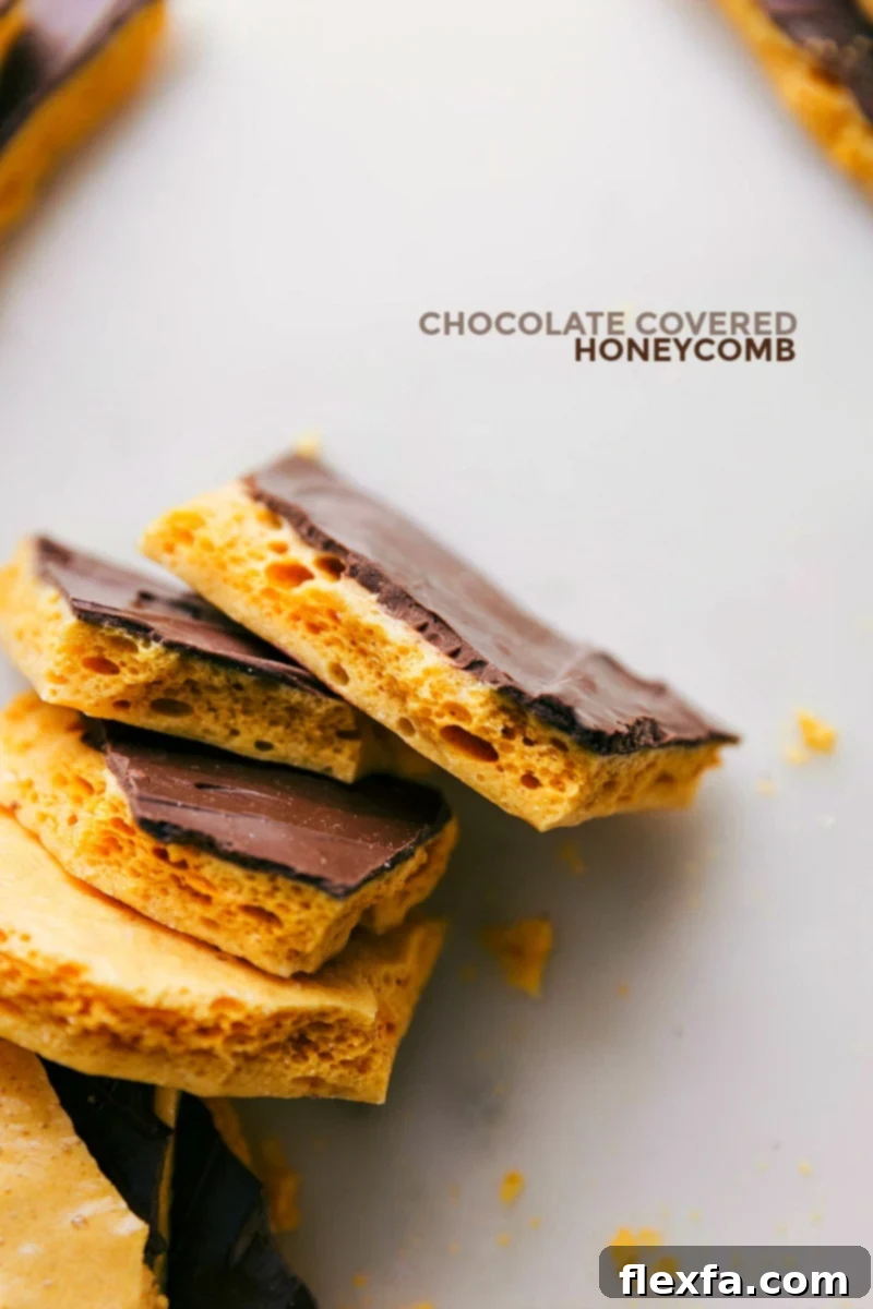 Golden, bubbly Homemade Honeycomb Candy pieces, some dipped in chocolate, on a serving platter, highlighting their perfect, airy texture.